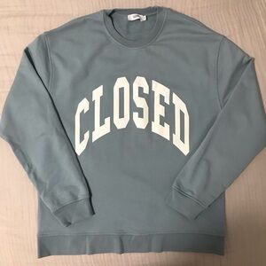 CLOSED branded light blue crew neck sweatshirts.